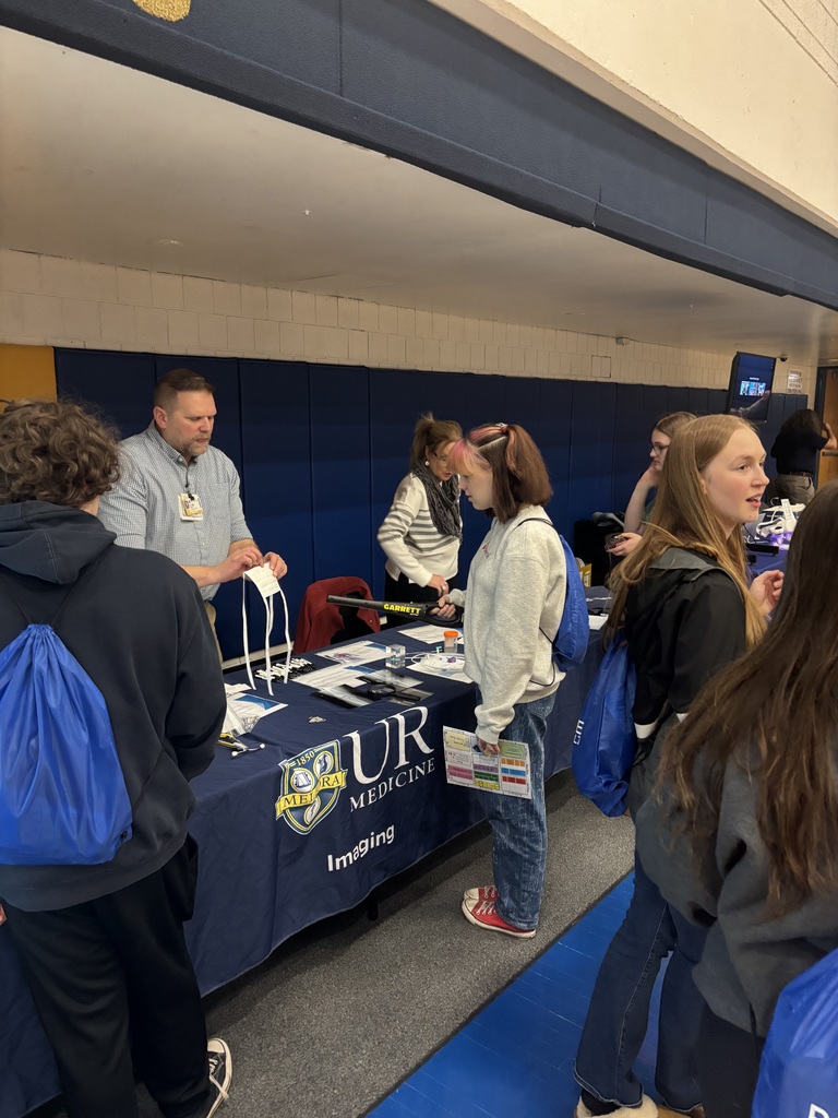 students watching a booth presentation