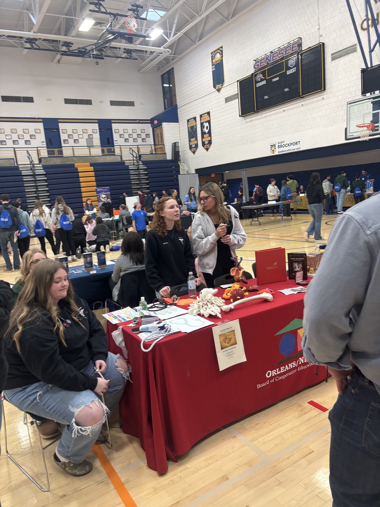 students watching a booth presentation