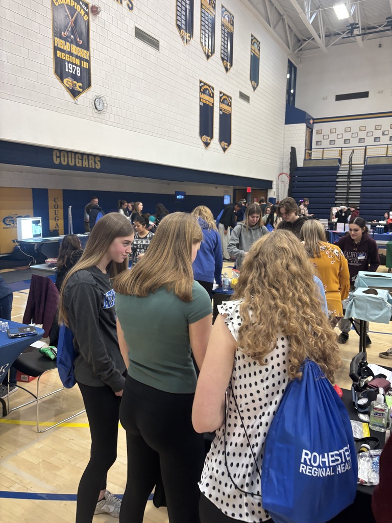 students watching a booth presentation