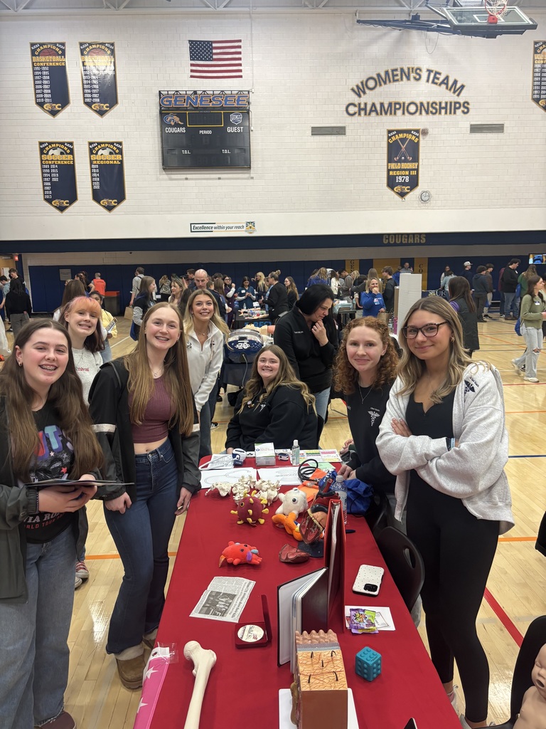 students watching a booth presentation