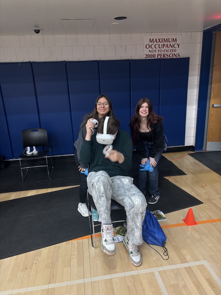 a student using virtual reality with two students observing