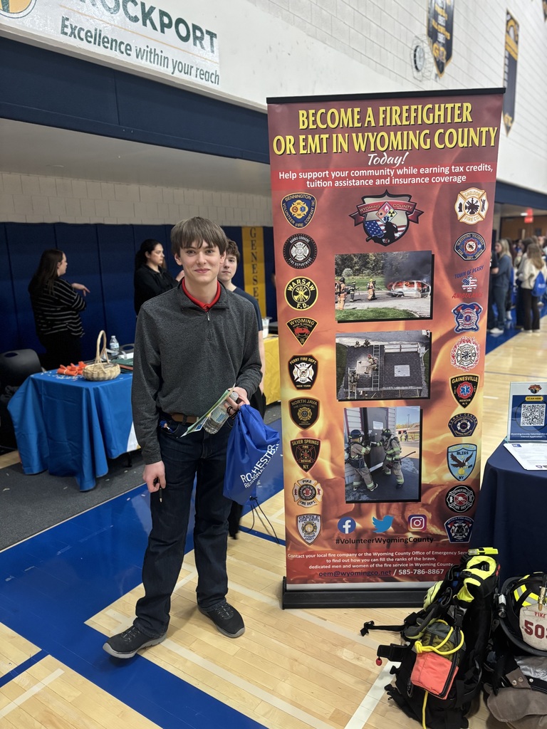 a student next to a booth at a health careers fair
