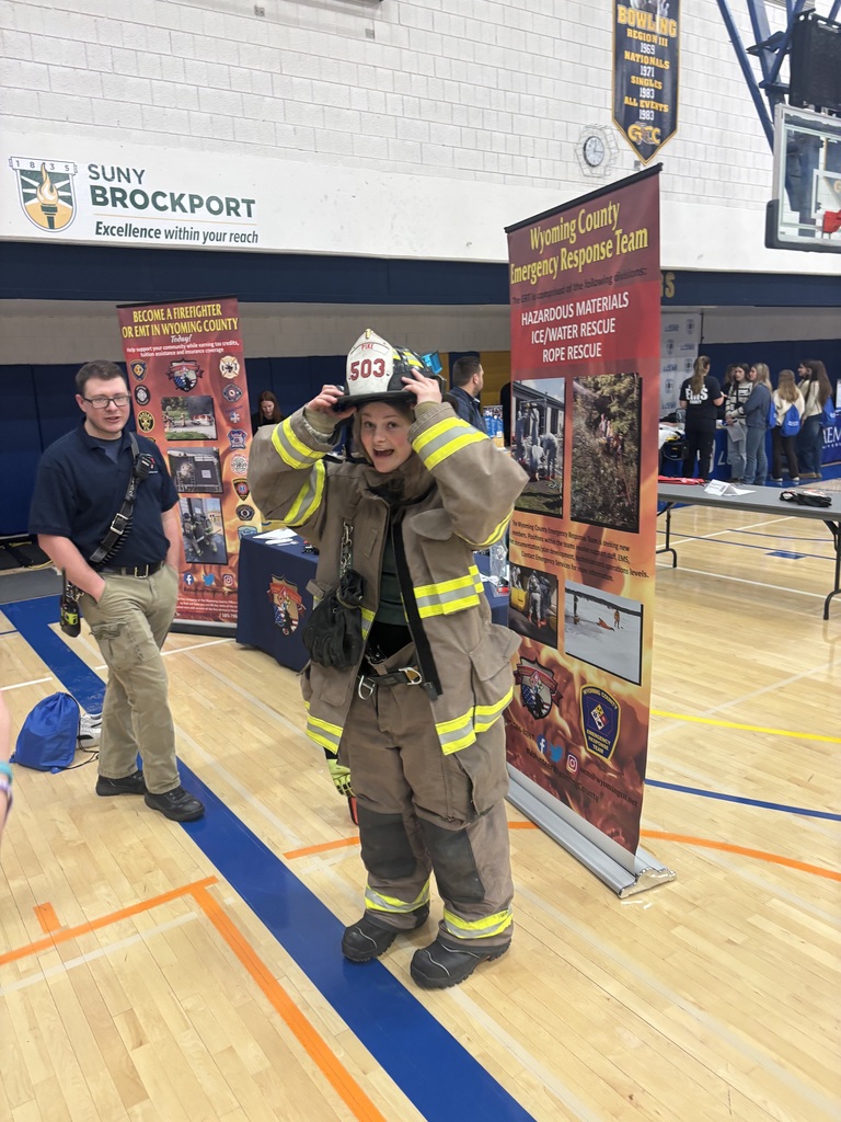 a student trying on firefighter equipment
