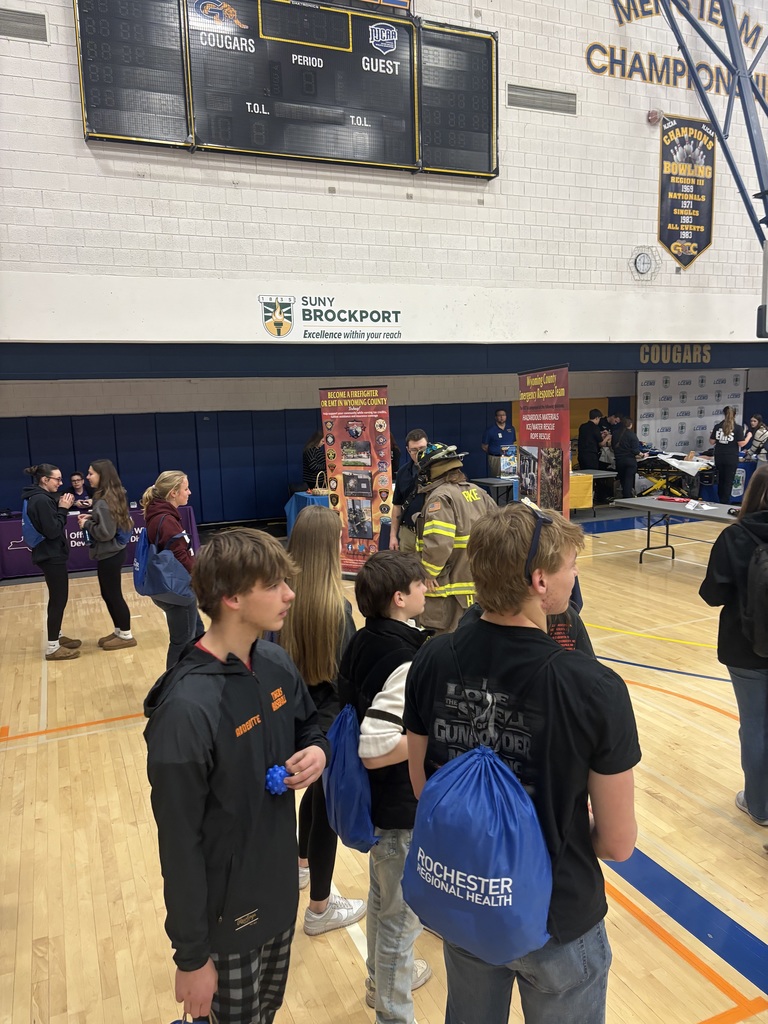 students watching a booth presentation