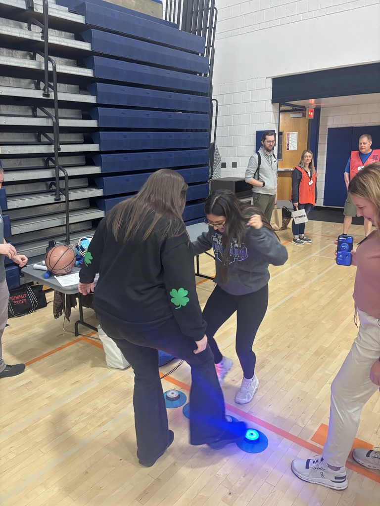 two students engaged in an activity with their feet at the health careers fair