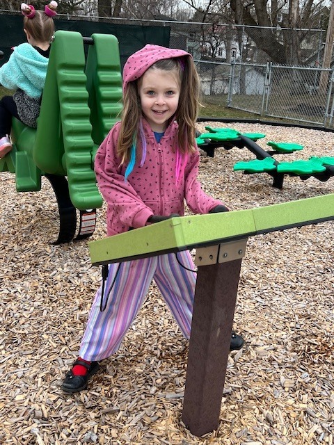 girl playing with outdoor toy