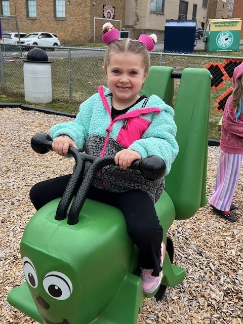 girl on toy on playground