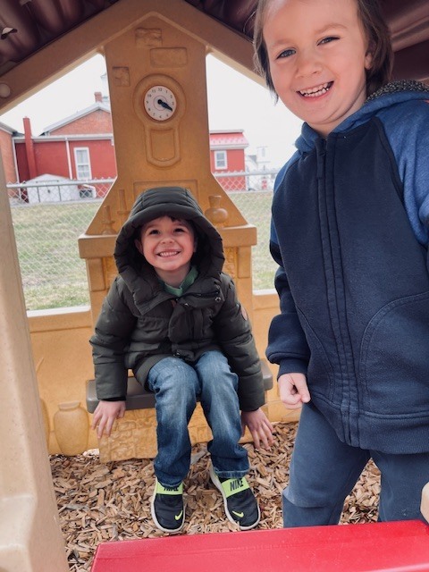 two students in house on playground
