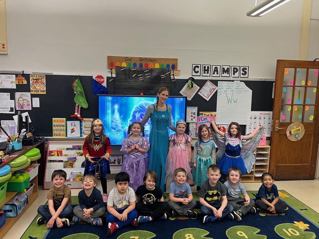 students and teacher dressed as superheroes or royals in classroom