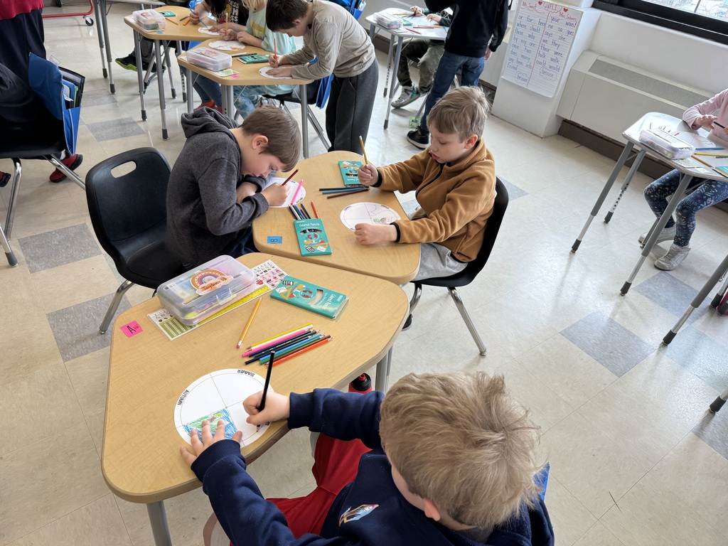 three boys working on project at desk