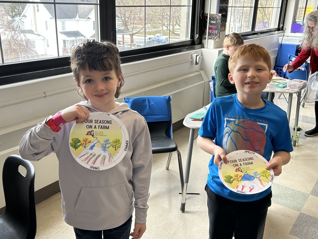 two boys showing their project