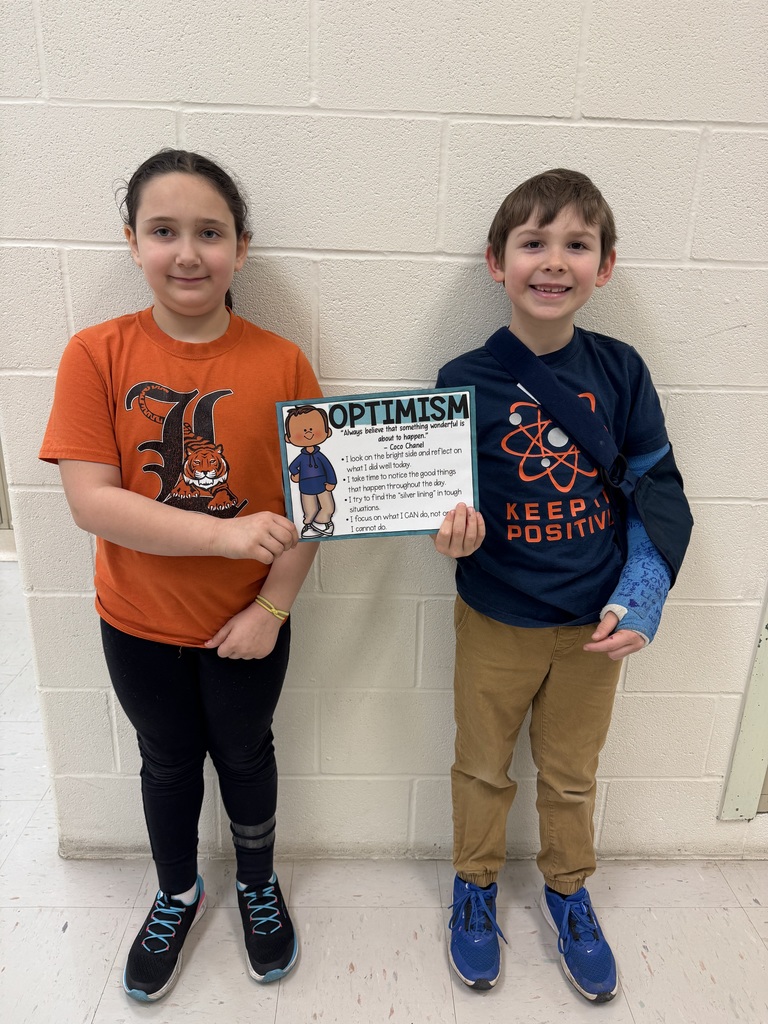 two students holding certificate