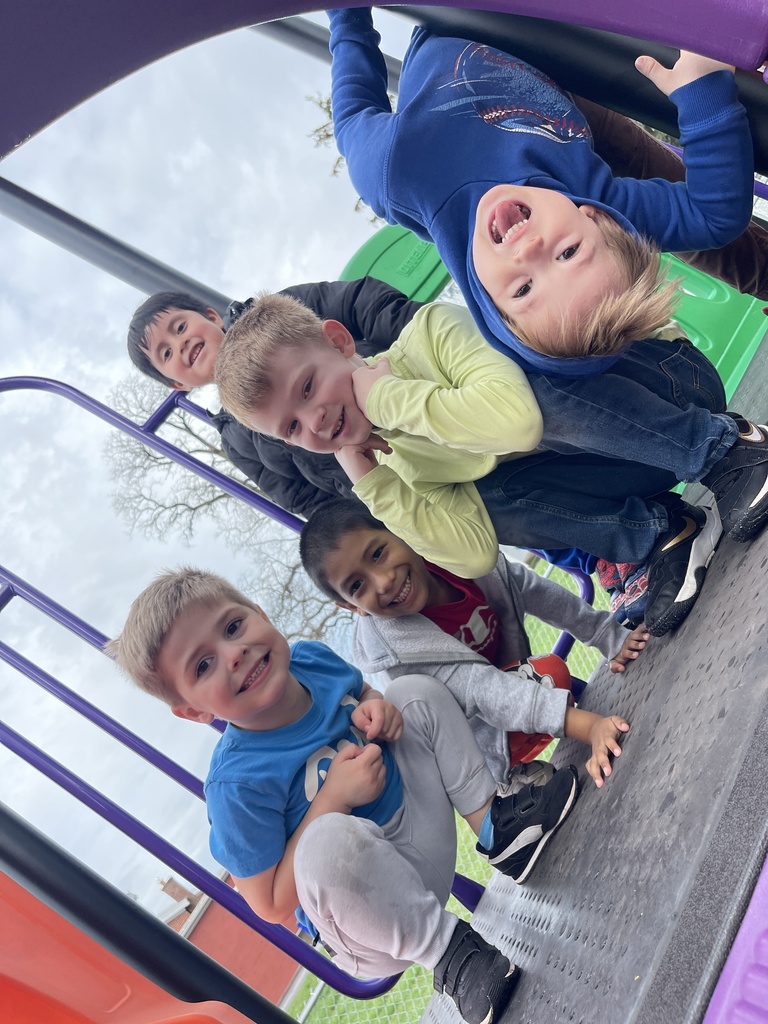 students playing on a piece of playground equipment