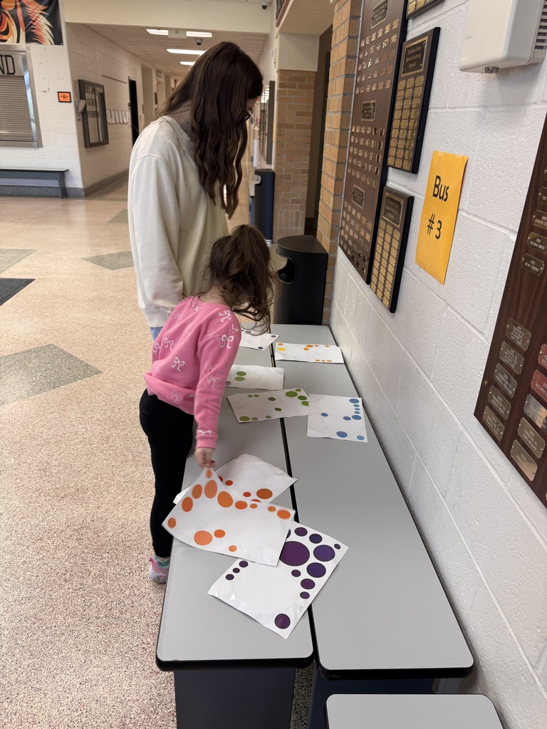 two students looking at polka dots on table