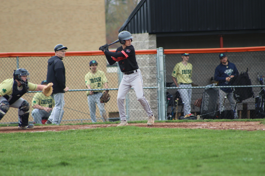 boy hitting ball with bat