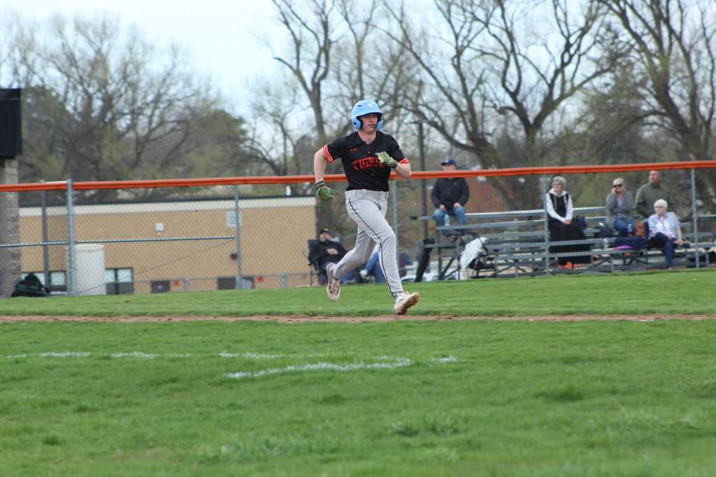 boy running to first base