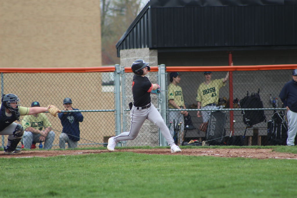 boy hitting ball with bat