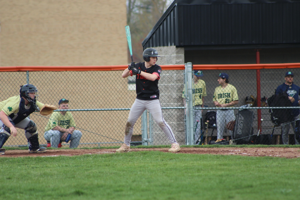 boy hitting ball with bat