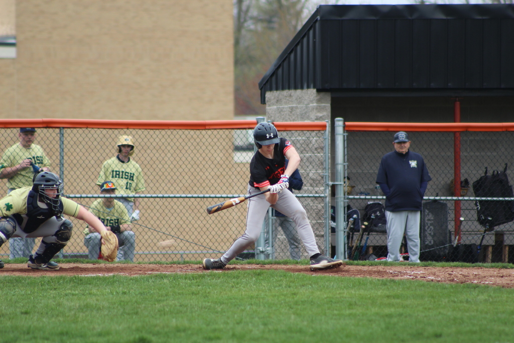 boy hitting ball with bat