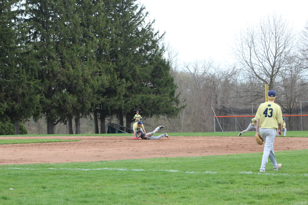 boy sliding into base in baseball game