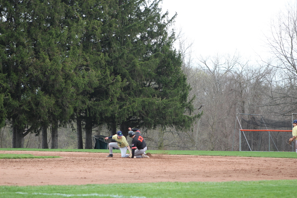 boy sliding into base in baseball game