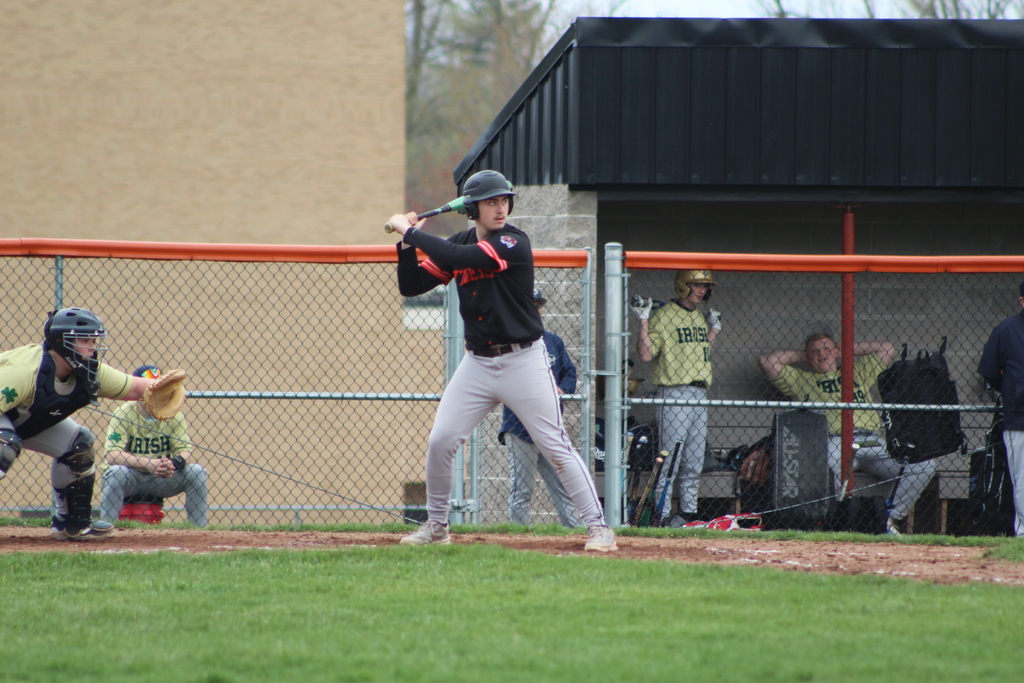 boy hitting ball with bat