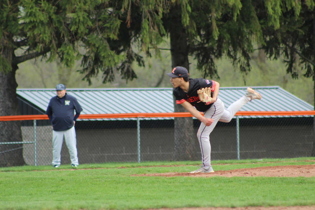 boy pitching in baseball game