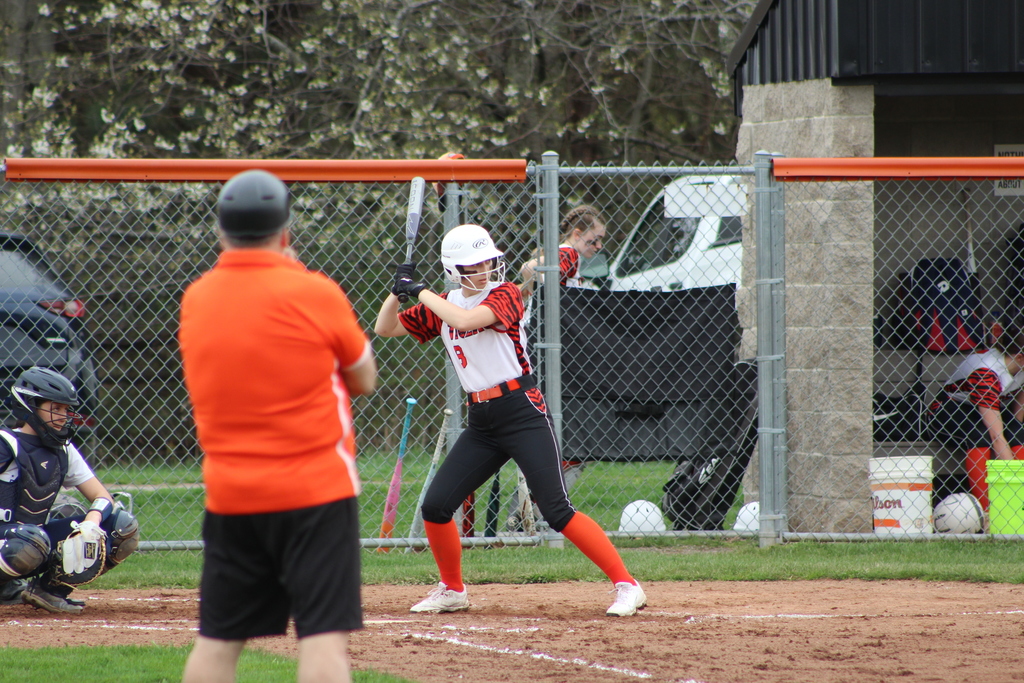girl hitting ball with bat