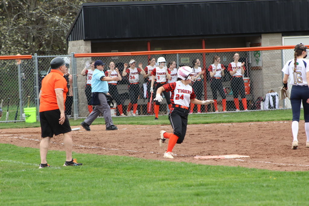 girl running to first base in softball game