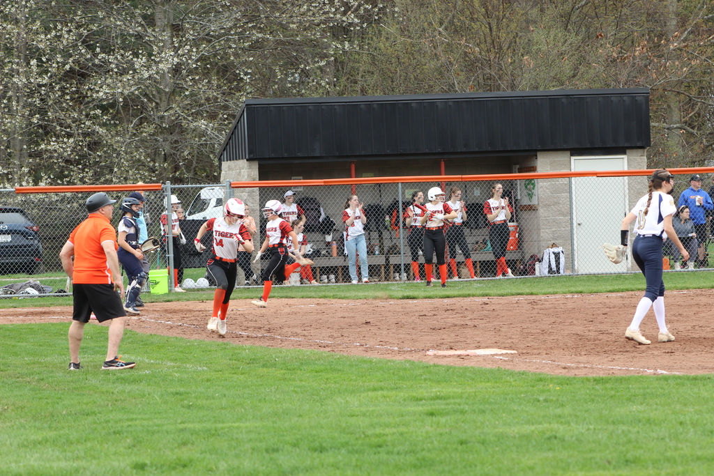 girl running to base in softball game