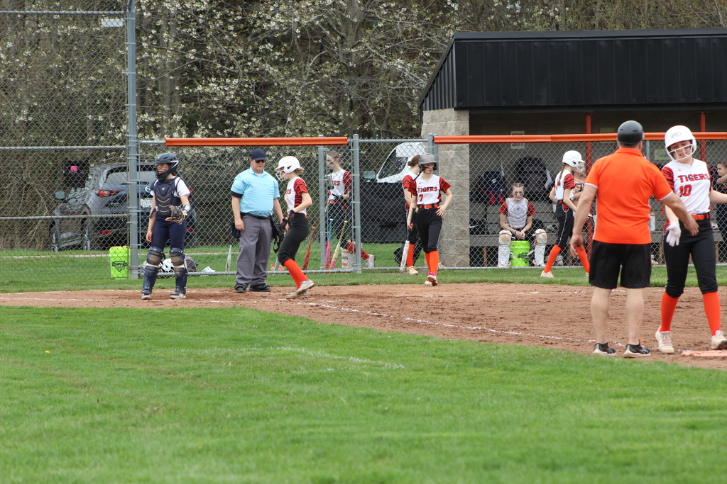 two girls running to bases in softball game