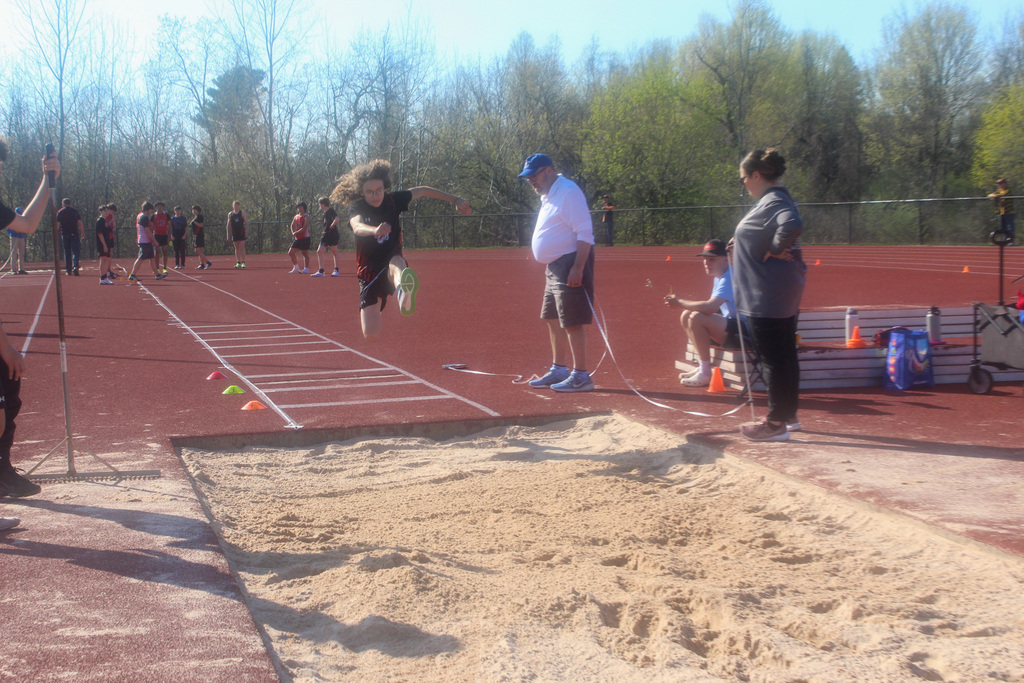 boy jumping into sand pit