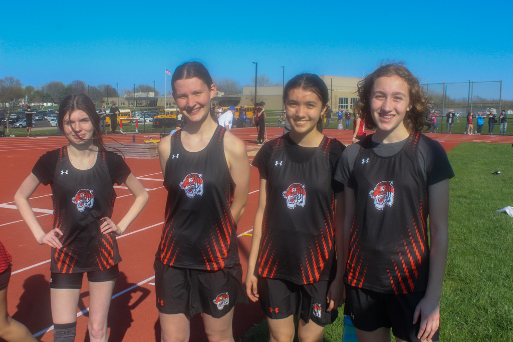 four girls in track uniforms