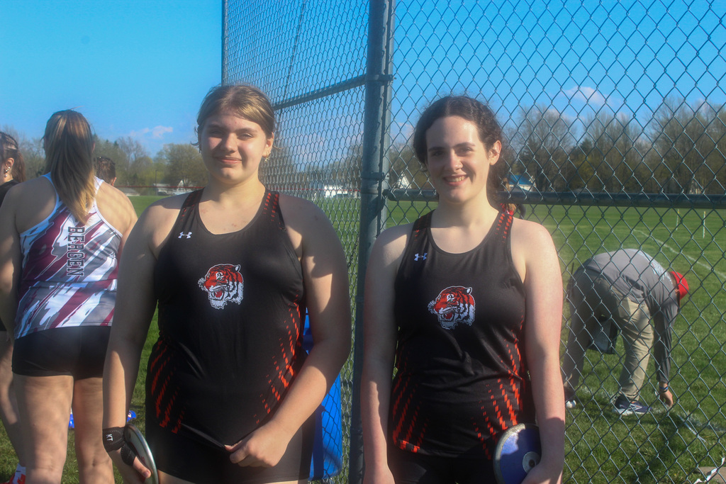 two girls in track uniforms