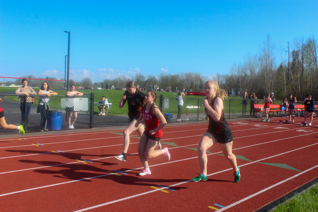 three girls running on track