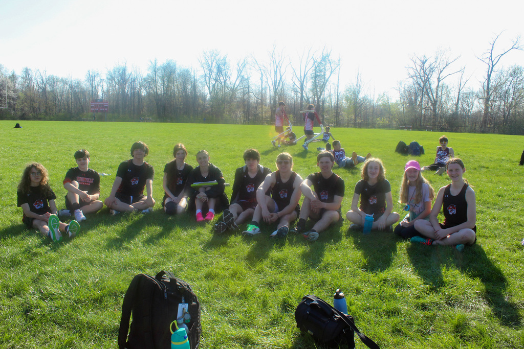 track teammates sitting on the ground together