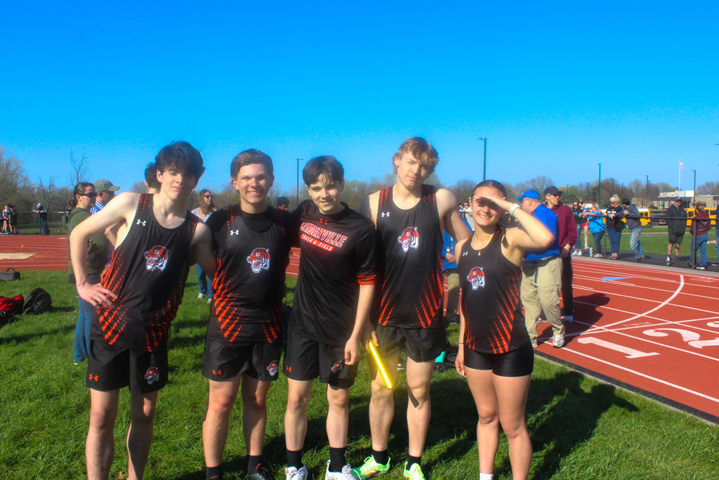 five track teammates in uniform standing together