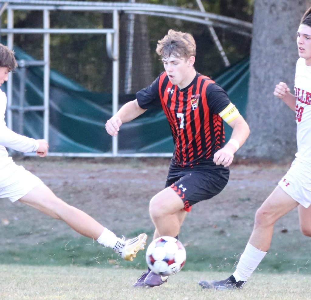 boy playing in a soccer game outside