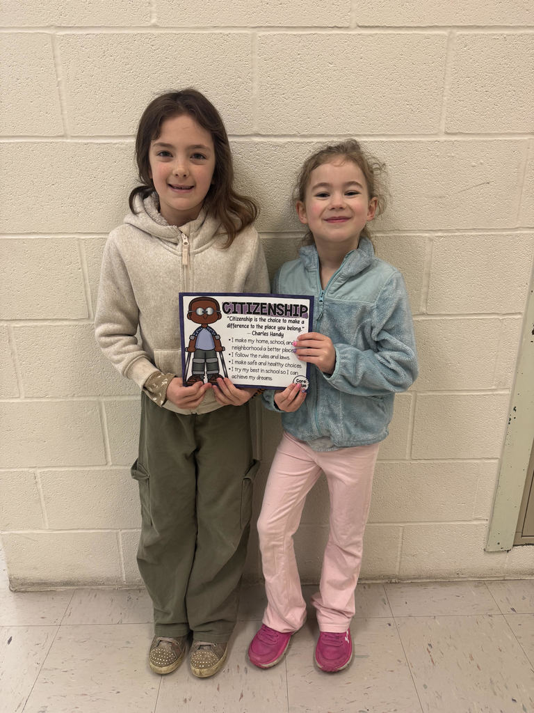 two students holding certificate