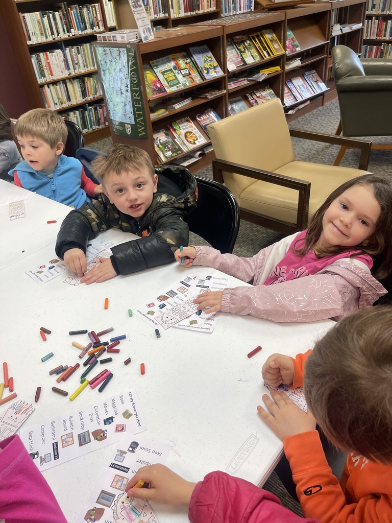 students coloring a worksheet at a table
