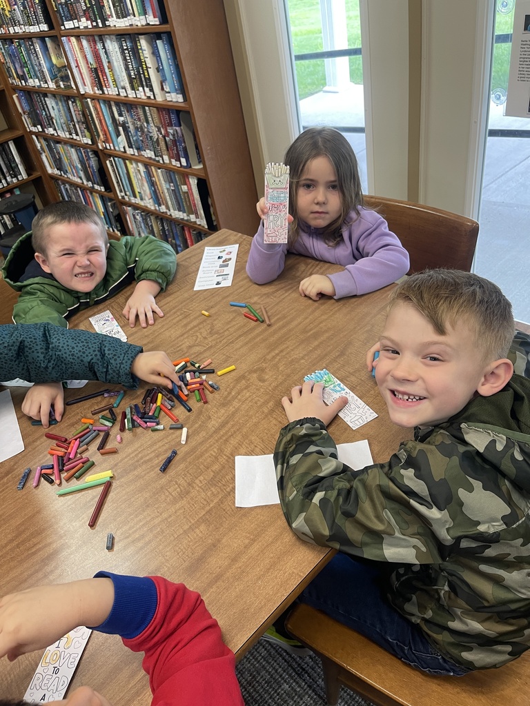 students coloring a worksheet at a table