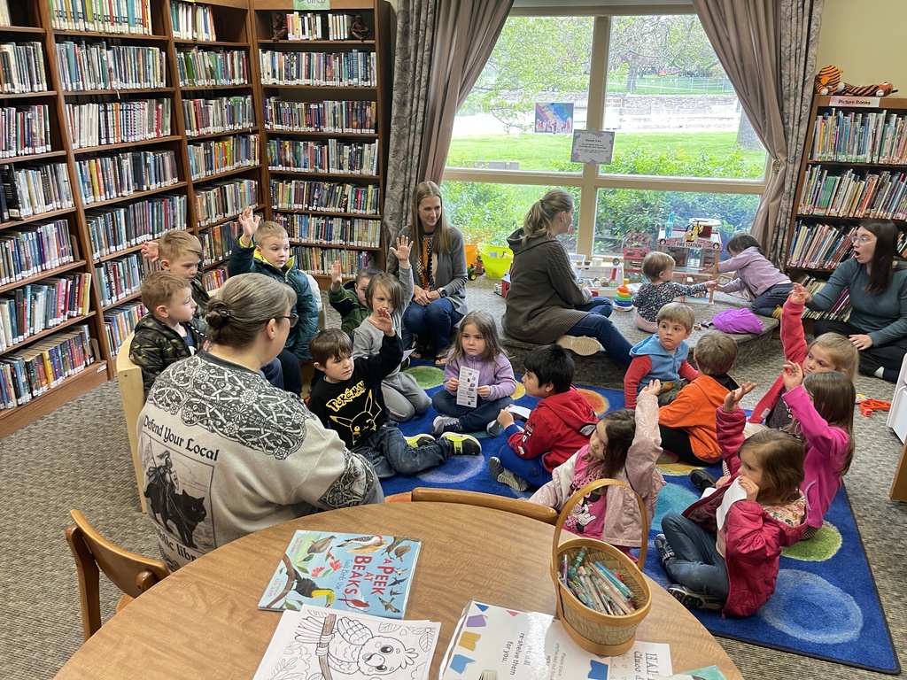 students and a few adults in a library together