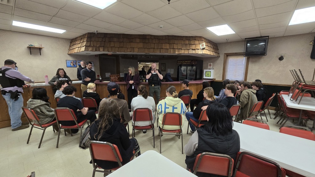 students listening to adults speak