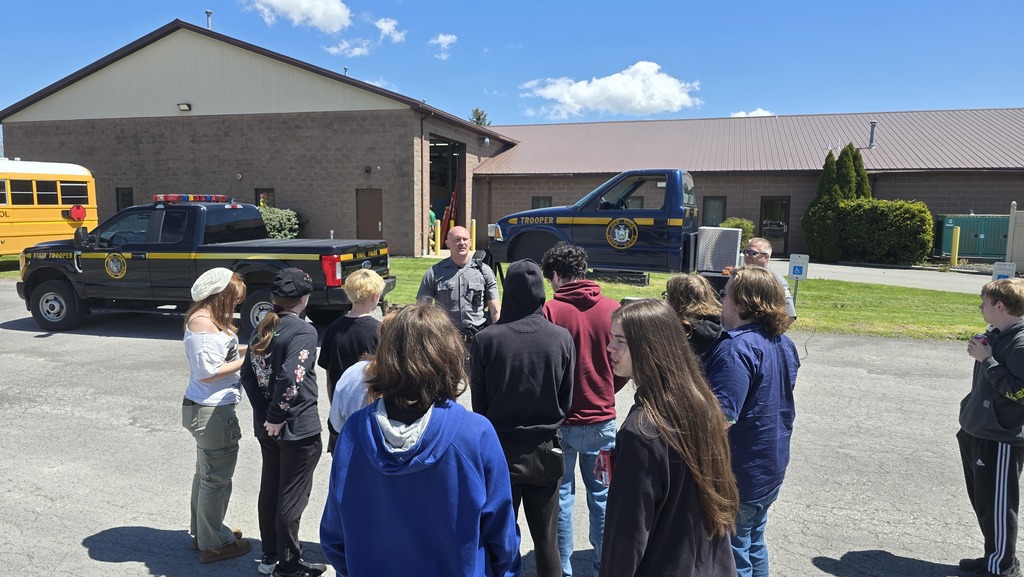 students listening to an adult speak
