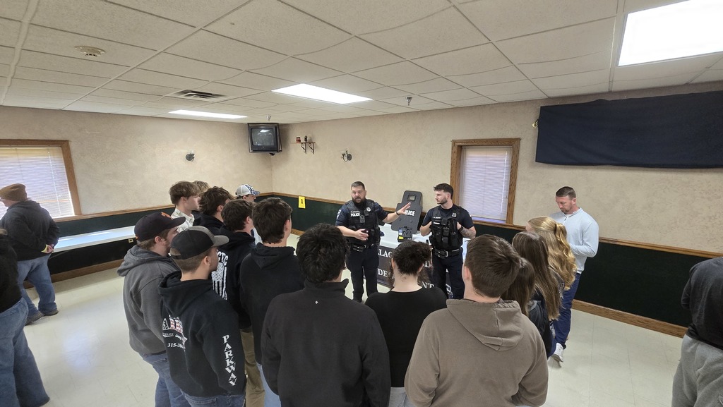 students listening to two law enforcement officers speak