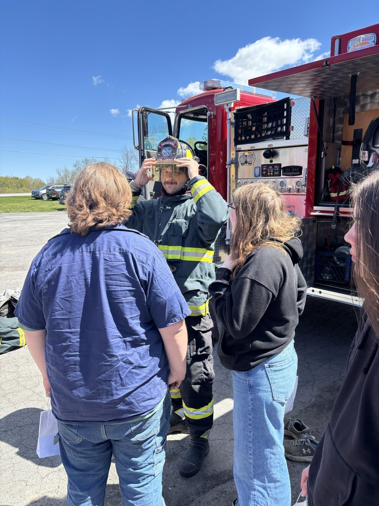 students talking to a firefighter