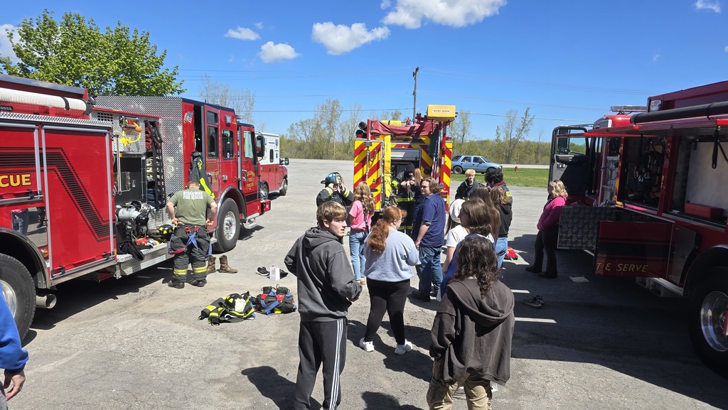 students lined up behind fire truck