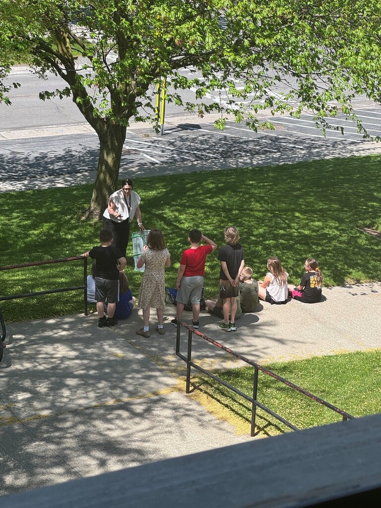 students outside listening to teacher