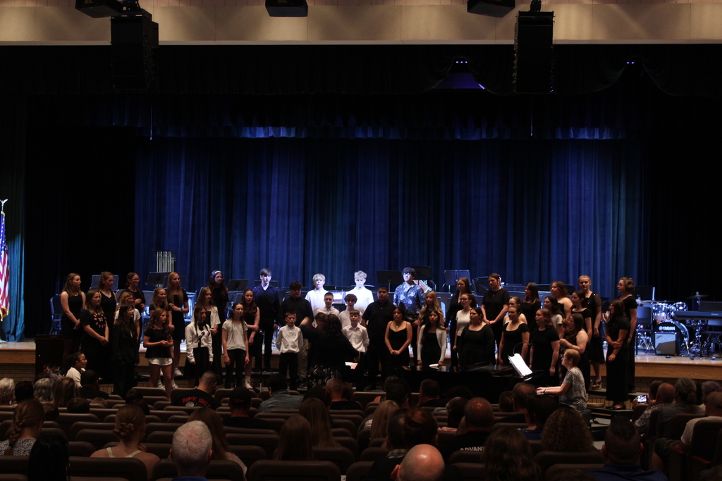 students singing in chorus on risers