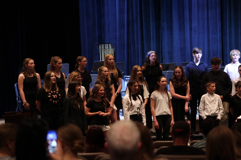 students singing in chorus on risers